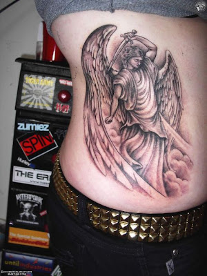 An elegant angel tattoo done on the arm in black ink looking beautiful.