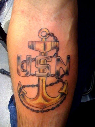 Gold navy anchor tattoo.