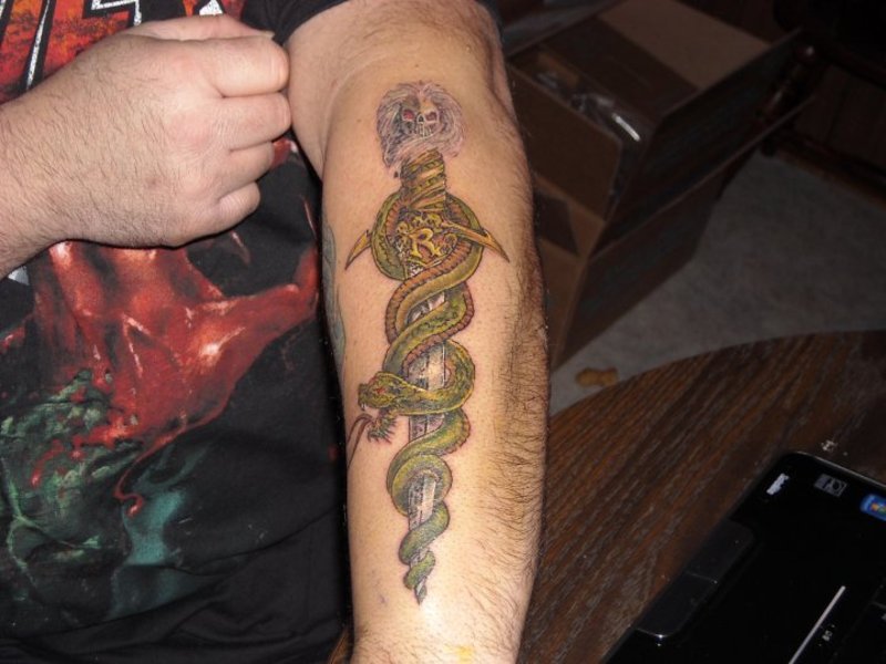 Skull snake and dagger tattoo.