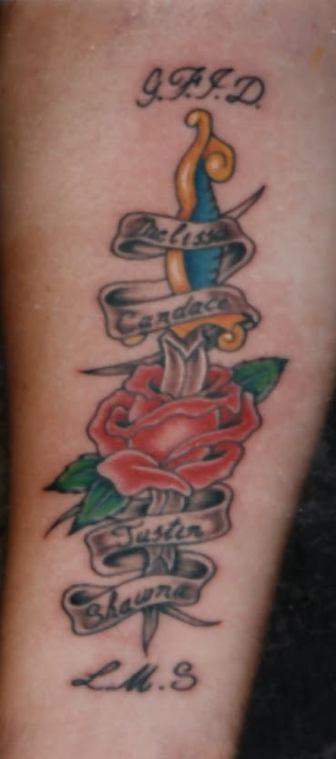 Rose and dagger with names tattoo.