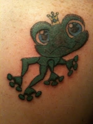 Cartoon frog with crown tattoo.