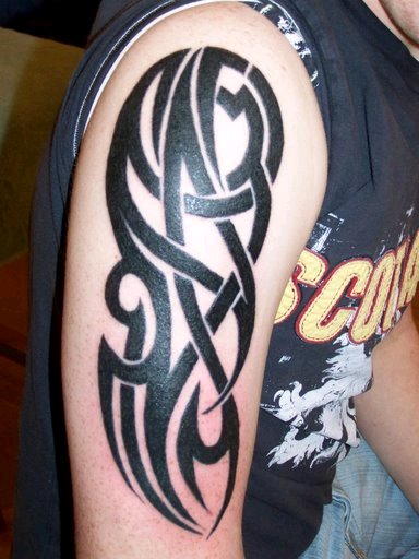 Colorful arm tattoo. Complex tribal 