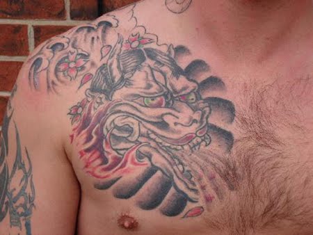 Dragon head chest tattoo.