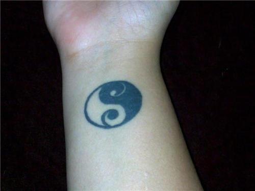 Yin yang tattoo design, one on each wrist.