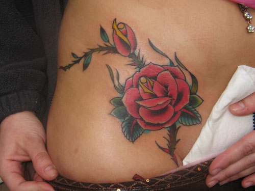 Though hip tattoos are covered and may be visible occasionally the tattoos