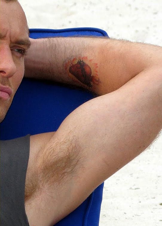 Lightning bolt design on right arm, which may or may not by a real tattoo. Lightning bolt design on right arm, which may or may not by a real tattoo.