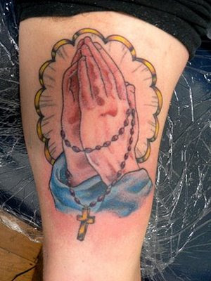 tattoos of praying hands with cross