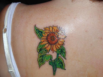 Cute small sunflower tattoo on back