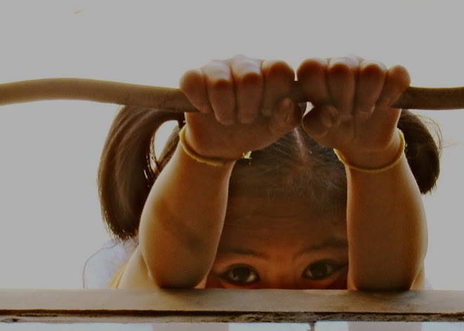 Girl peering through window