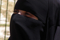 Muslim woman veiled so only eyes are showing