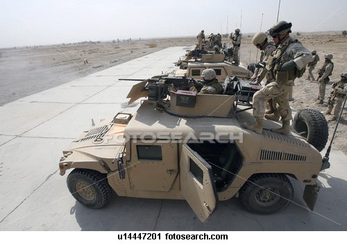 Humvees on standby in the dessert.