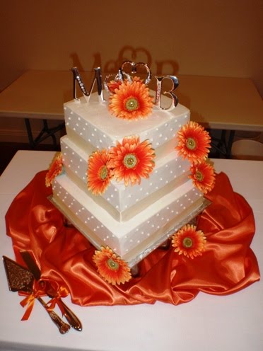 Square White and Orange Wedding Cake Posted by J Edwards Fine Chocolates