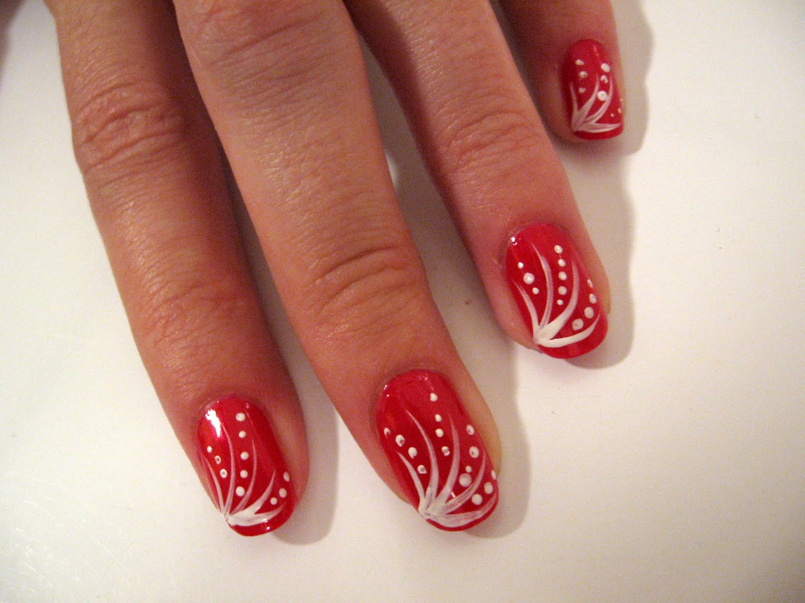 Homemade nails: Red nails with white lines and dots