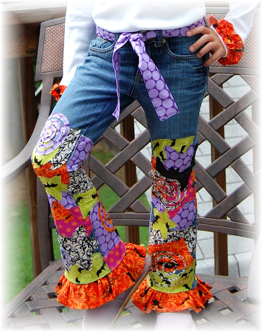 `CLOSEUP OF SPIDER JEANS SET