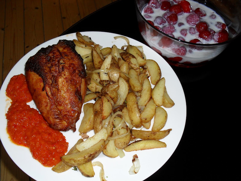 Plate with Chicken Breast, Potato wedges and Ajvar. Bowl with strawberries, vanilla protien