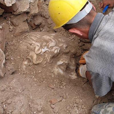 An archaeologist excavates the head of the statue at the site of the bath house in Salagassos, Turkey. BBC. Copyright: Sagalassos Archaeological Research Project