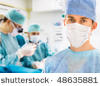 [stock-photo-male-surgeon-with-two-doctors-on-background-in-operation-room-48635881[1].jpg]