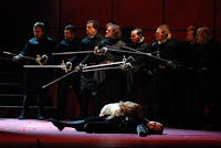 Swords drawn over the dead lovers.