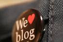 This is a picture of a black pen sayin we love blog in white