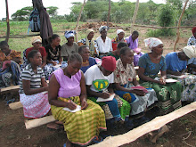 Women taking notes from microfinance lesson