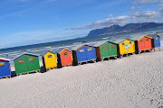 Colourful beach huts @ Muizenberg: Surfers on the beach: (dsc )