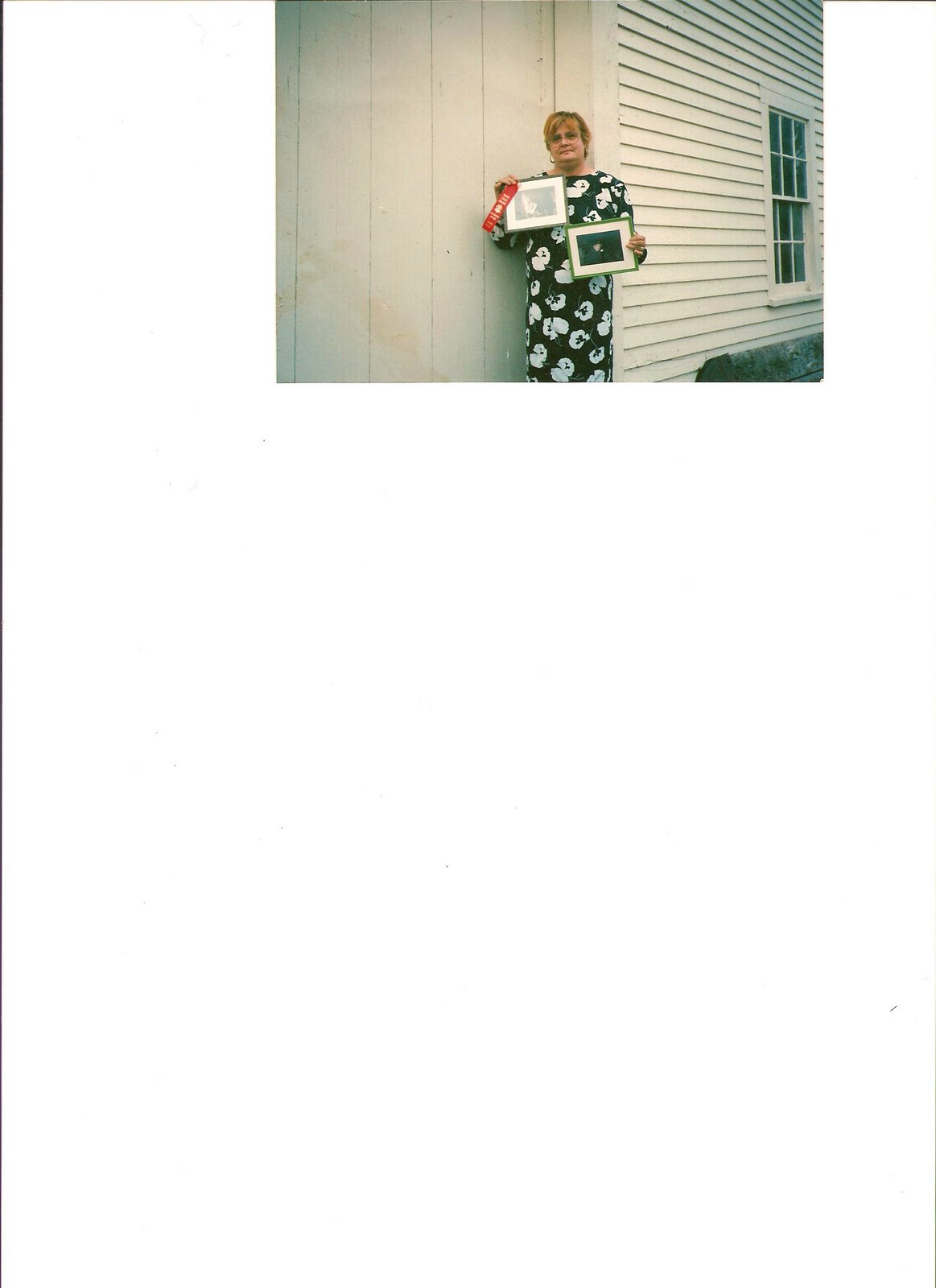 Dixie showing her red ribbon paintings