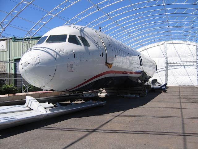 a white airplane in a hangar