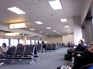 people sitting in an airport waiting area