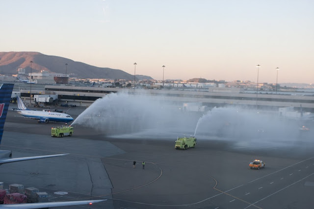 a firetrucks spraying water on a runway