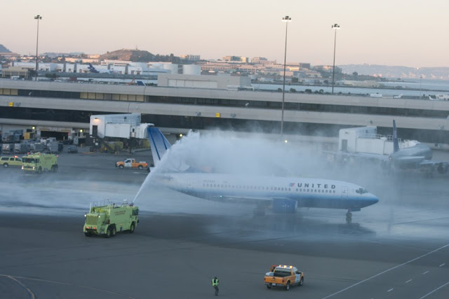 a jet spraying water on an airport