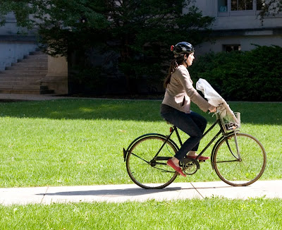 woman on three speed bike with a package