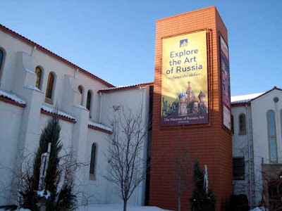 Exterior of church-turned-museum with banner reading Explore the Art of Russia