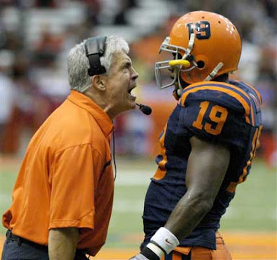 Male adult coach screaming at a football player