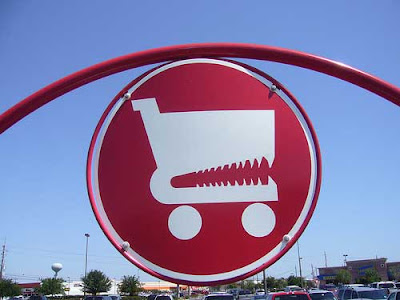 Sign with red shopping cart that looks like it has teeth