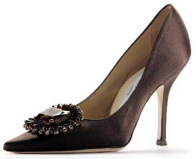 Black stiletto shoe with a large fake jewel near the pointed toe