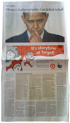 Newspaper page with full-width closeup photo of Obama looking downward. Red and black Target ad goes full width below the photo, with Thing 1 and Thing 2 bounding around promoting Storytime at Target