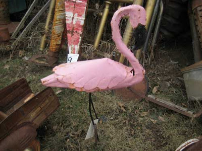 A pink painted flamingo made out of iron or steel