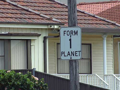 Photo of a black and white altered street sign, now reading FORM 1 PLANET instead of FORM 1 LANE