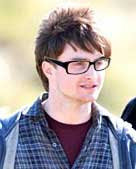 Daniel Radcliff with black geekish glasses and a bit more five o'clock shadow