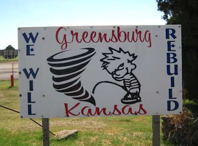 Sign reading We Will Rebuild, showing Calvin peeing on a tornado