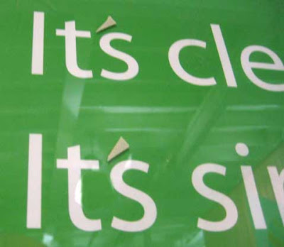 Close up of the green sign. The apostrophes in It's were added on top of the plexiglass