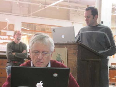 James Clough at his laptop with Bill and Jim Moran in the background