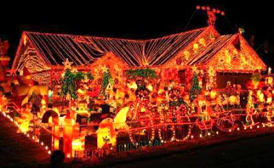 Festooned Christmas lights and figures on a house