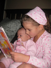 Charlotte sharing a book with Lucy at Bedtime
