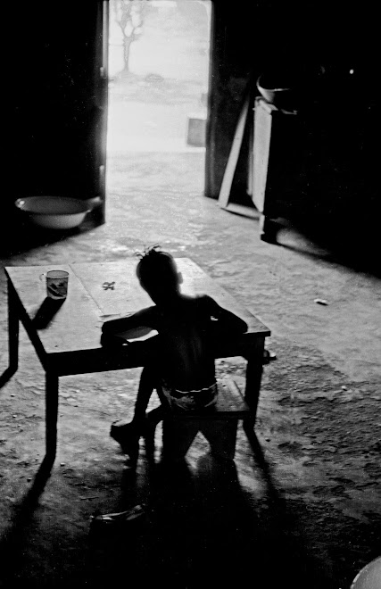 child at table at 55 Dama Rd. in Kenema