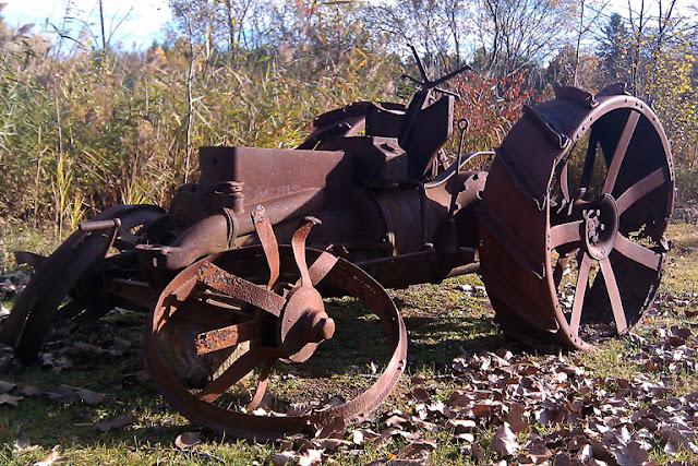 An old rusted tractor behind the Farmington River Diner & Deli in Otis Massachusetts