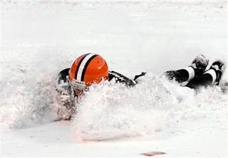 Derek Anderson slides in the snowy end zone to celebrate the Browns victory over the Bills