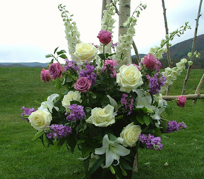 Purple and pink stock white lilies pinkish purple roses and white roses