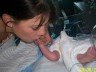 Me, Auntie Lela kissing baby R's foot when he was just a few hours old.