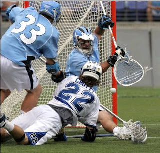 Evans(#33) and Jess Schartzmann stop shot by Duke's Ned Crotty Evans(#33) and Schartzmann stop shot by Duke's Ned Crotty